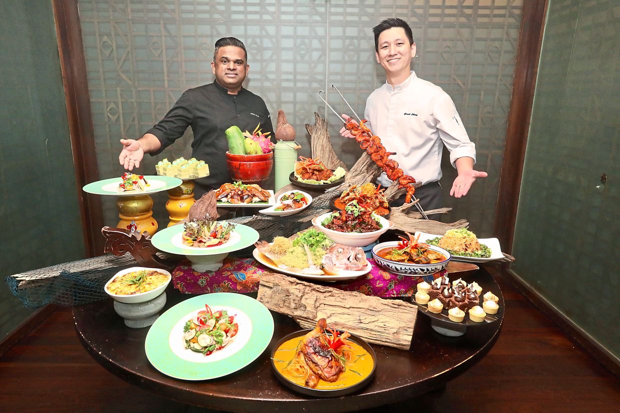 Doubletree by Hilton Kuala Lumpur executive sous chef Murli Pillay (left) and executive chef Gerald Chong with some of their creations for Sustainability on a Plate buffet. — Photos: SHAARI CHEMAT/The Star