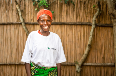 SWSN participant smiling in front of their home